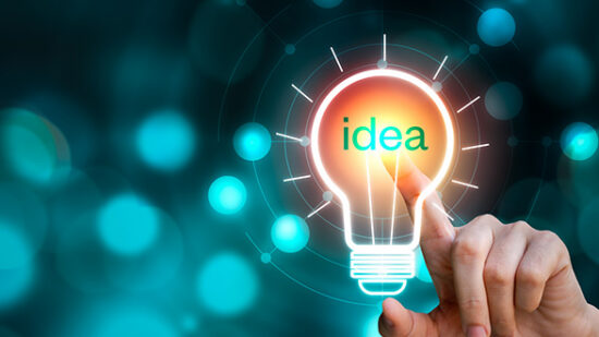 Hand touching the light bulb sign with idea text on blurred background. Creative innovation
