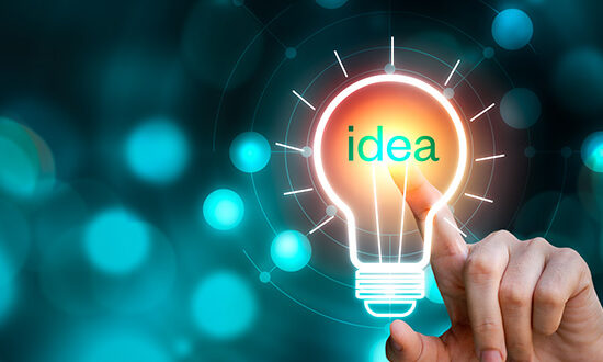 Hand touching the light bulb sign with idea text on blurred background. Creative innovation
